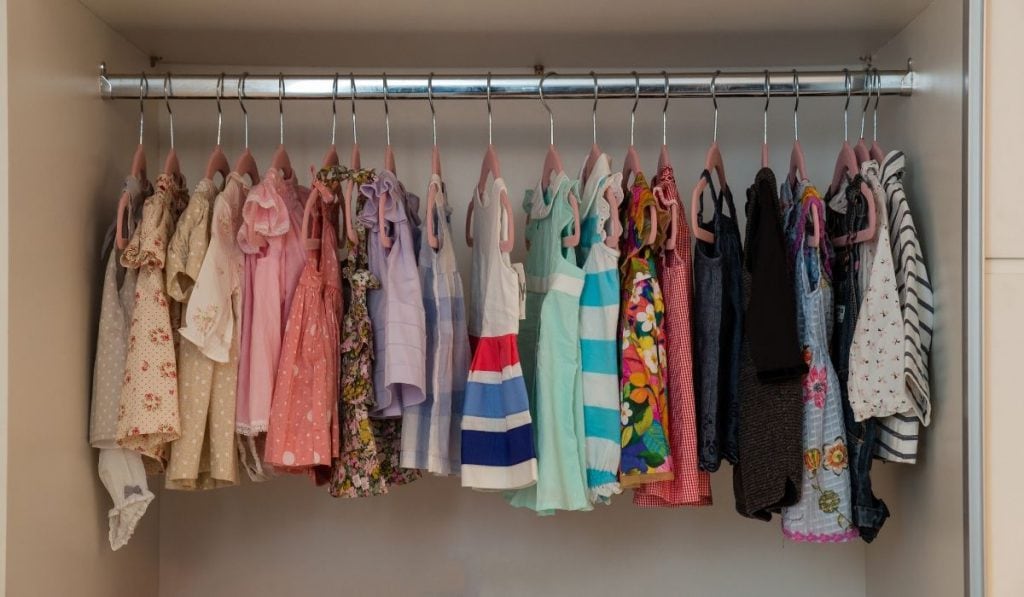 toddler's dresses hangs in the cabinet