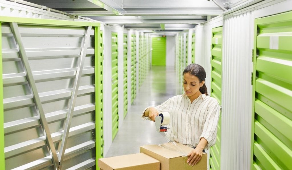 lady packing boxes in a storage facility