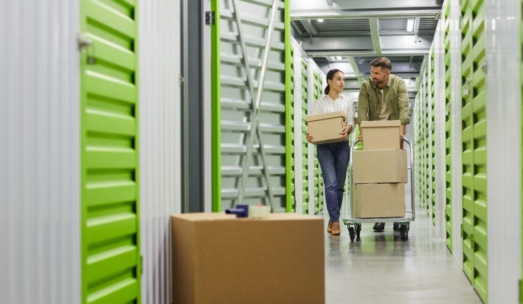 couple bringing in boxes to store in their storage unit